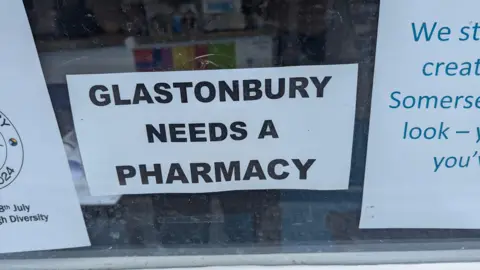 Paul Manning A sign in a window reading 'Glastonbury needs a pharmacy'.