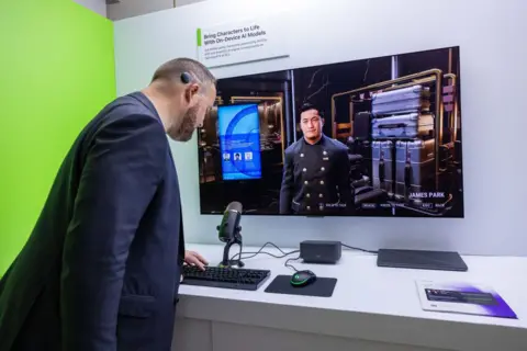 A convention attendee stands in front of a screen displaying a CPU-controlled character in a 3D environment. The man in front of the screen is leaning over a keyboard. A sign above the screen reads "bring characters to life with on-device AI models".