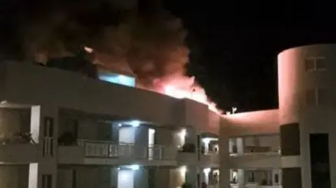 A fire on the roof of a hotel