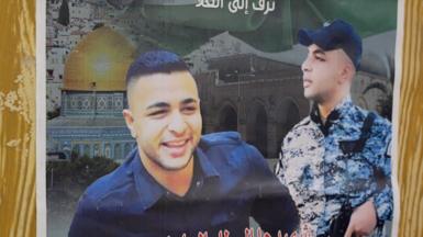 A poster shows the smiling picture of a young man who was killed