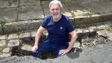 Alan from Macclesfield standing in the pothole he found