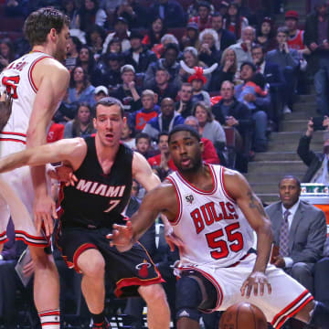 Chicago Bulls guard E'Twaun Moore (55) slips while driving around Miami Heat guard Goran Dragic (7) during the first quarter at the United Center. Mandatory Credit: Dennis Wierzbicki-USA TODAY Sports