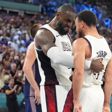 Aug 8, 2024; Paris, France; United States guard LeBron James (6) and shooting guard Stephen Curry (4) celebrate after the game against Serbia  in a men's basketball semifinal game during the Paris 2024 Olympic Summer Games at Accor Arena. Mandatory Credit: Rob Schumacher-USA TODAY Sports