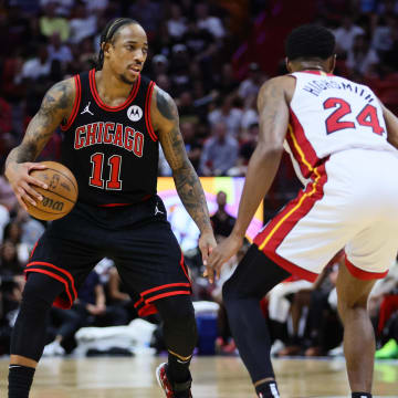 Apr 19, 2024; Miami, Florida, USA; Chicago Bulls forward DeMar DeRozan (11) dribbles the basketball as Miami Heat forward Haywood Highsmith (24) defends in the first quarter during a play-in game of the 2024 NBA playoffs at Kaseya Center. Mandatory Credit: Sam Navarro-USA TODAY Sports