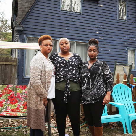 Monique, Ashley Gunn and Alicia stand outside Ashley's house