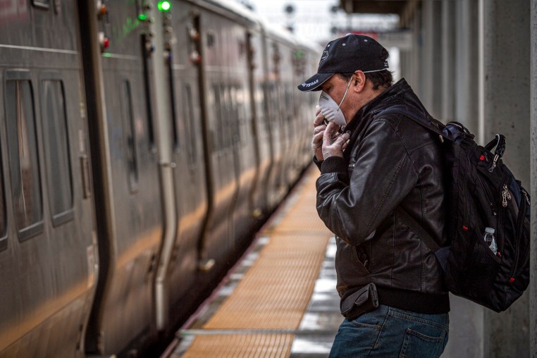 Commuter wears face mask while waiting for train on Long Island 