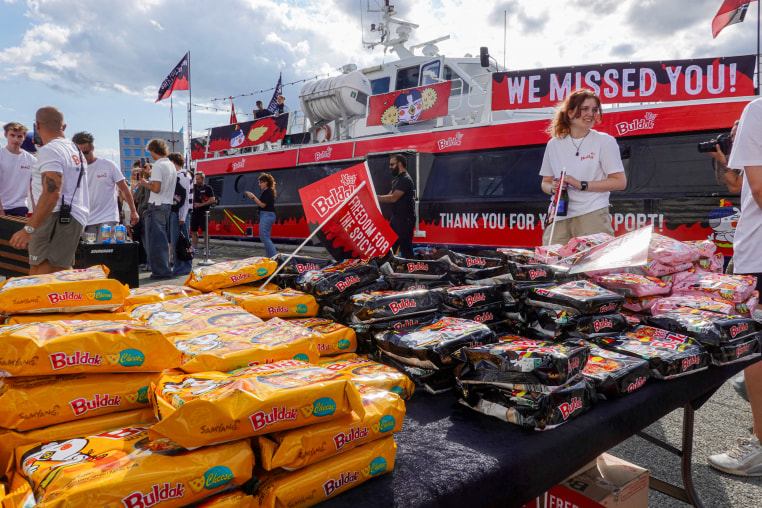 Packets of Buldak ramen by a boat.