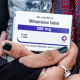 Close up of hands holding a box of mifepristone pills