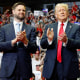  J.D. Vance and Donald Trump stand onstage during a campaign rally at the Van Andel Arena in Grand Rapids, Mich.,