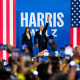 Kamala Harris and Tim Walz wave to the crowd