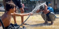 Two kids playing with water.