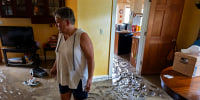 Ann Farkas walks in her flood-damaged home in Canisteo, N.Y., Friday, Aug. 9, 2024, after remnants of Tropical Storm Debby swept through the area, creating flash flood conditions in some areas.