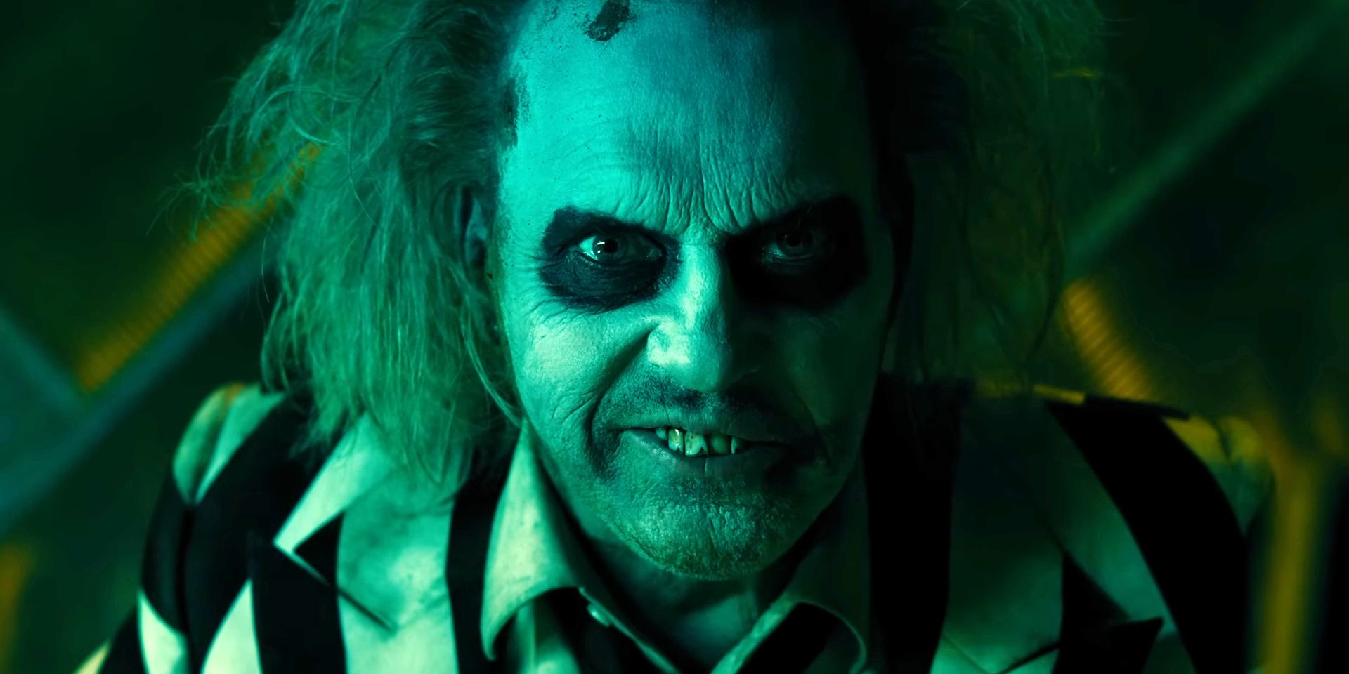 Beetlejuice grins maniacally in close-up in Beetlejuice Beetlejuice